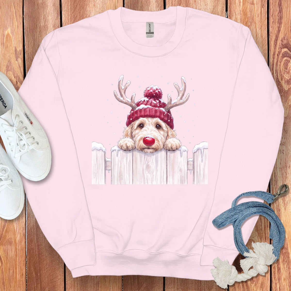 Pink sweatshirt with a festive doodle dog wearing a Santa hat and reindeer antlers.
