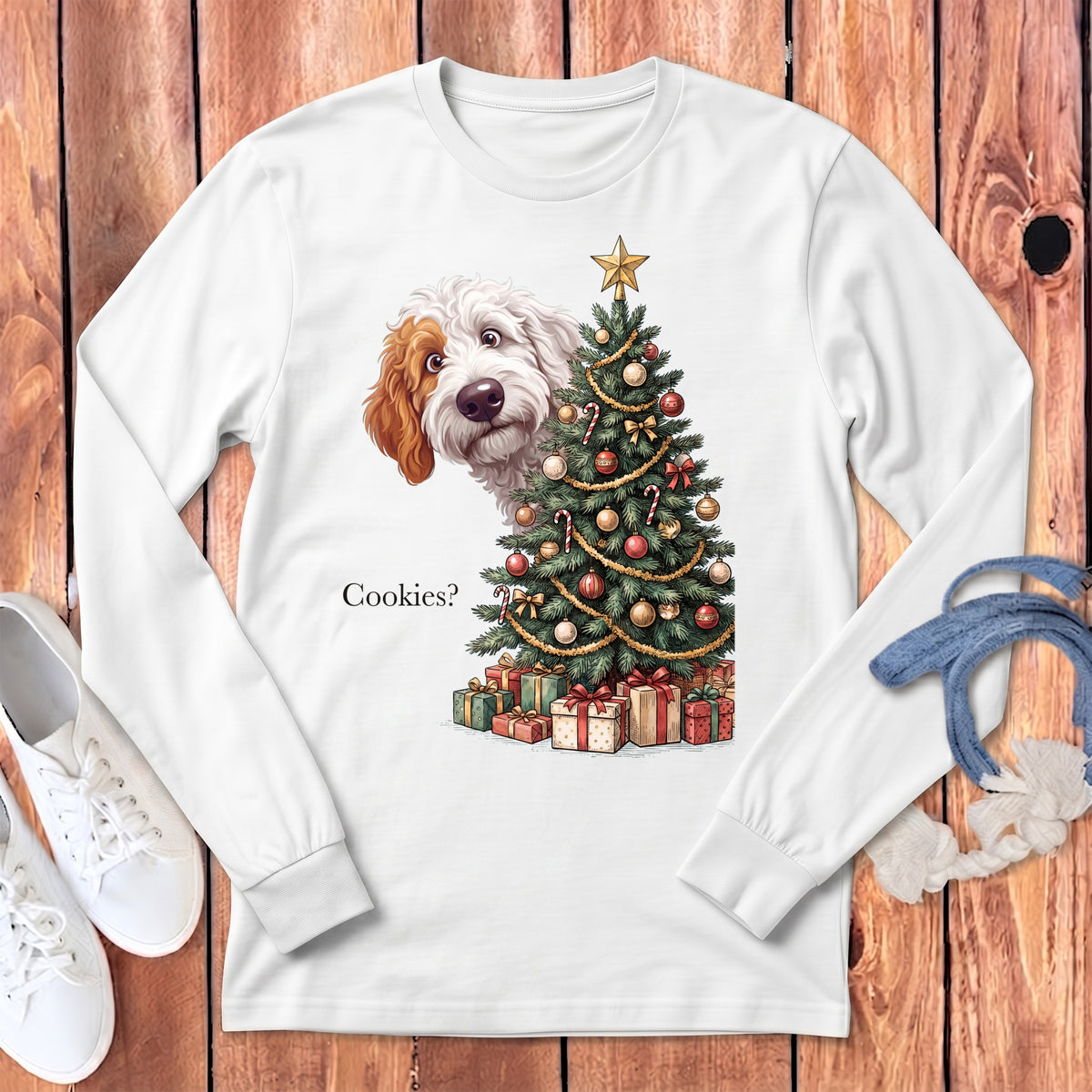 White long-sleeve shirt with a doodle dog peeking behind a Christmas tree and presents.