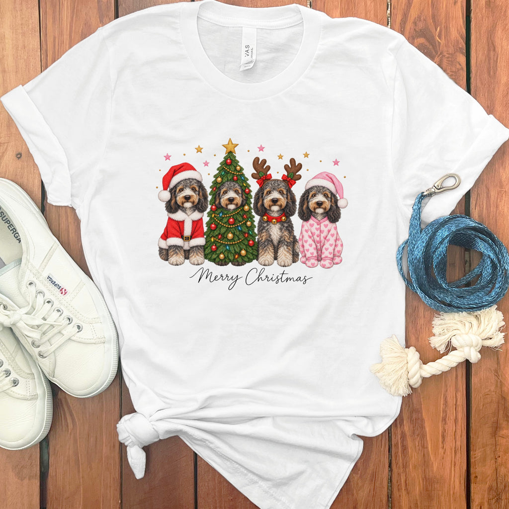 White t-shirt with a graphic of four doodle dogs celebrating Christmas, surrounded by sneakers and a leash.