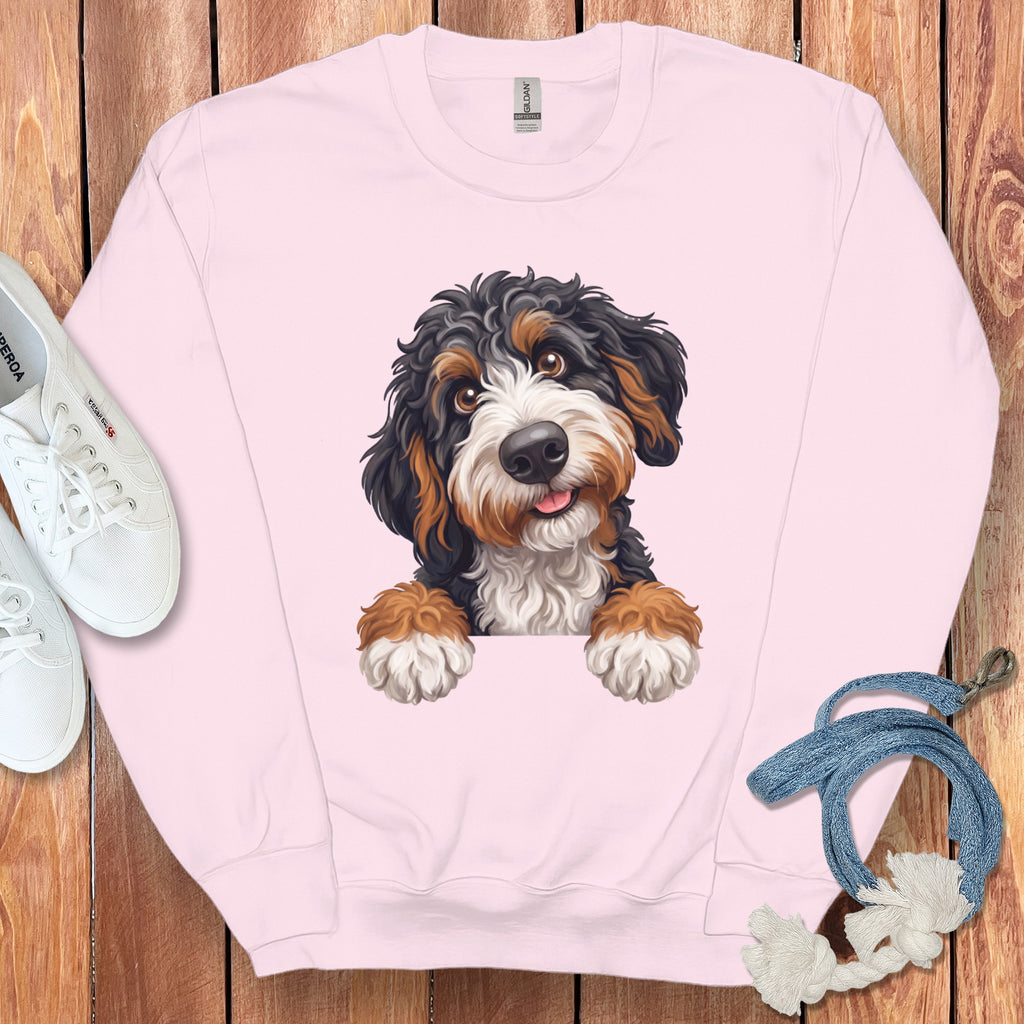 Pink sweatshirt with a Bernese Mountain Dog puppy graphic and white sneakers.