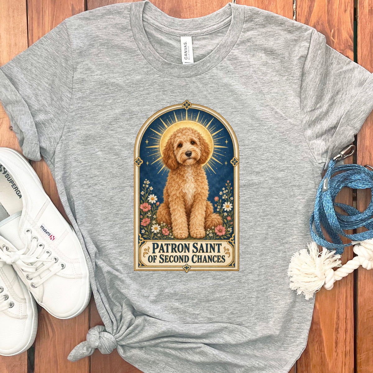 Grey t-shirt with a doodle dog illustration captioned "Patron Saint of Second Chances".