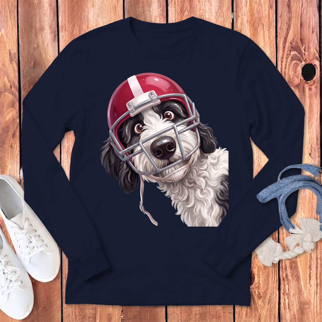 Black and white dog wearing a red football helmet and facemask on a navy shirt.