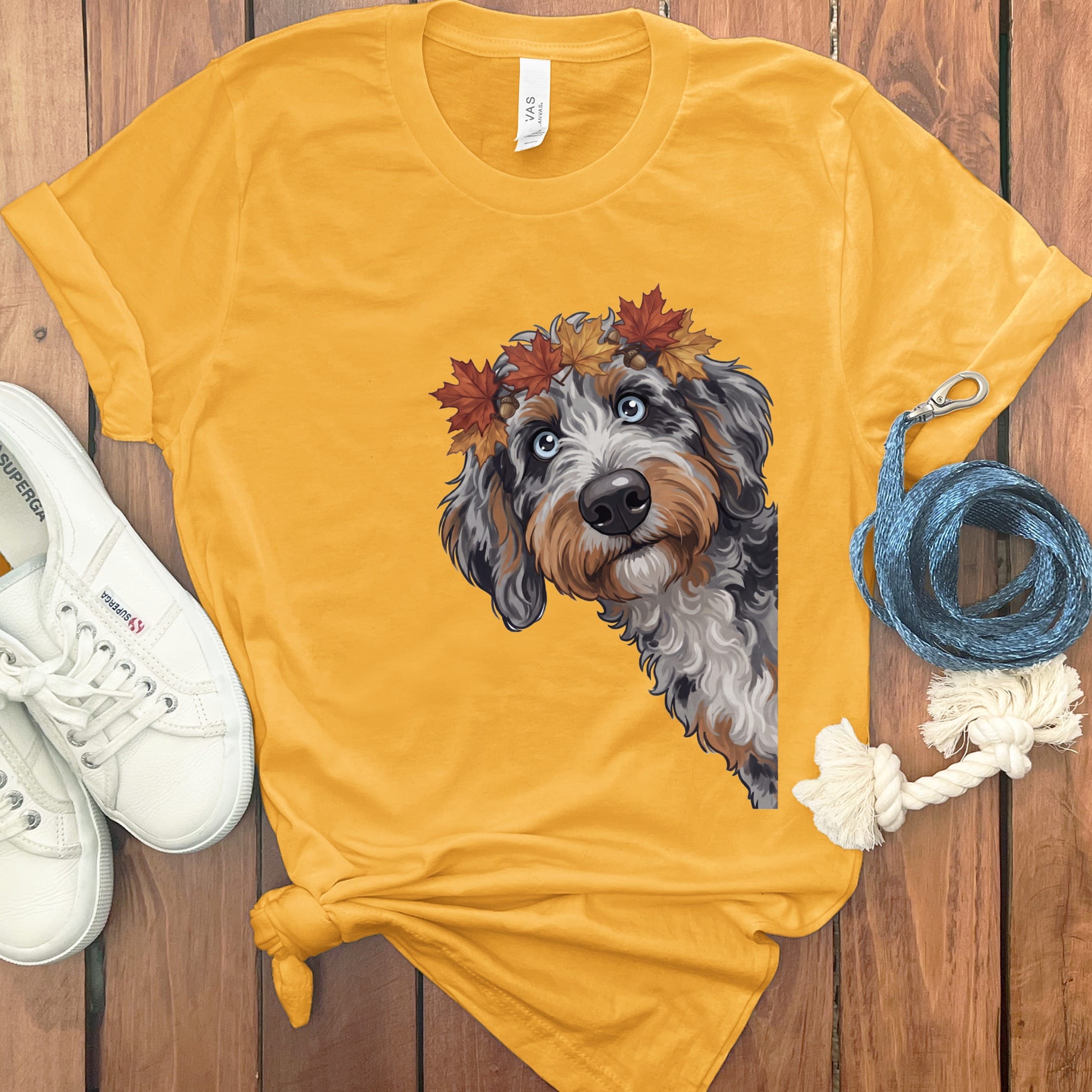 Yellow t-shirt with illustrated dog wearing a fall leaves crown.