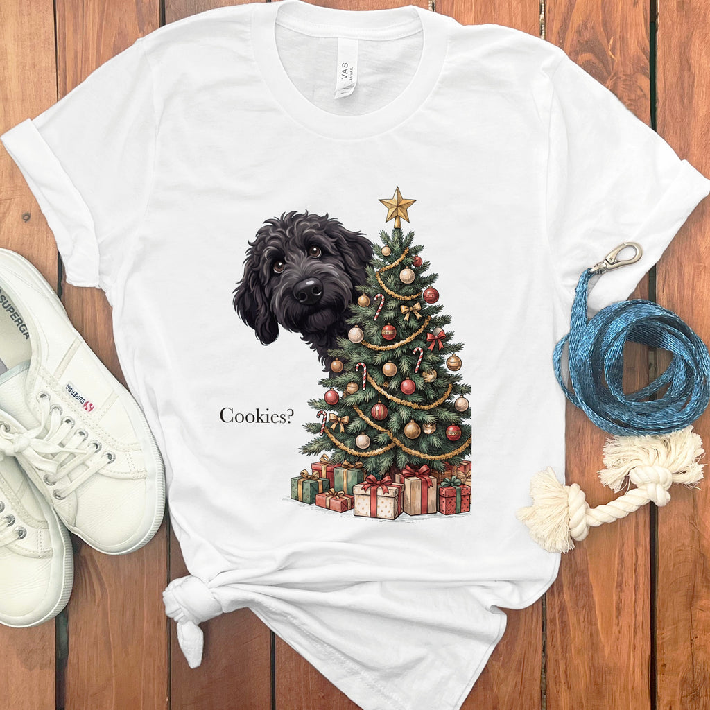 White t-shirt with a black dog peeking from behind a Christmas tree asking "Cookies?".