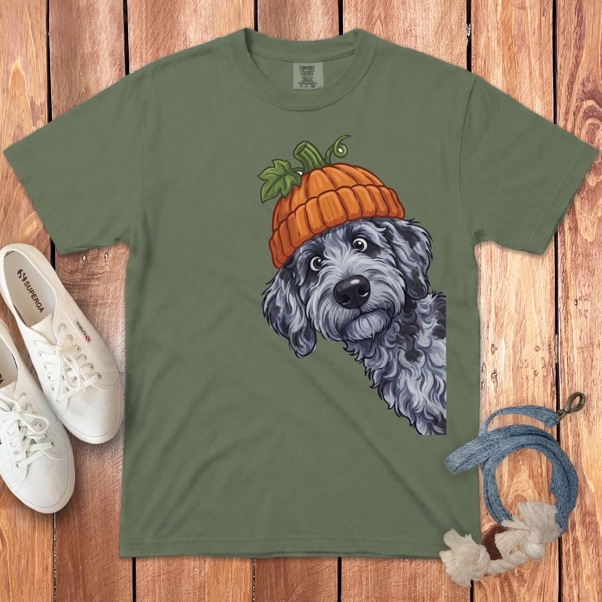 Green t-shirt with a gray dog wearing a pumpkin hat graphic.