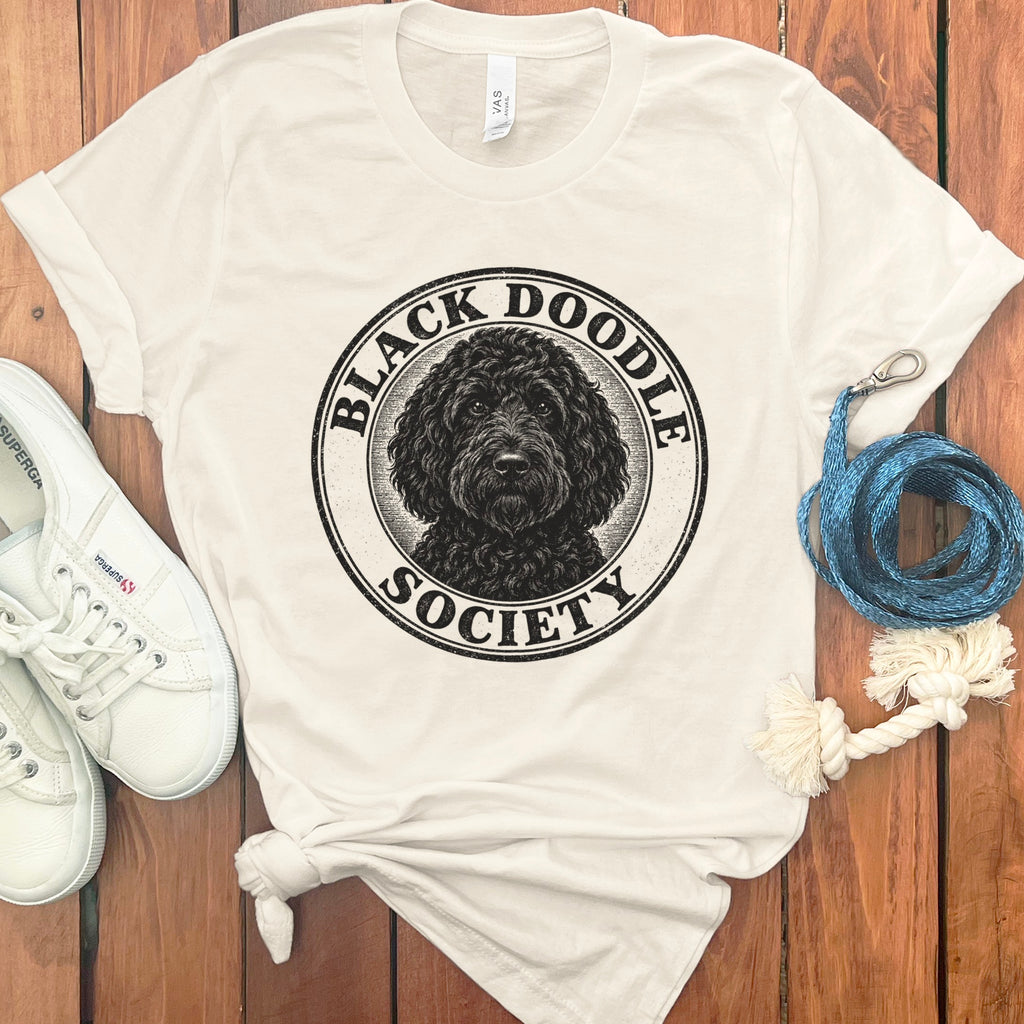 Cream t-shirt with a distressed circular logo of a black doodle dog and text "Black Doodle Society".