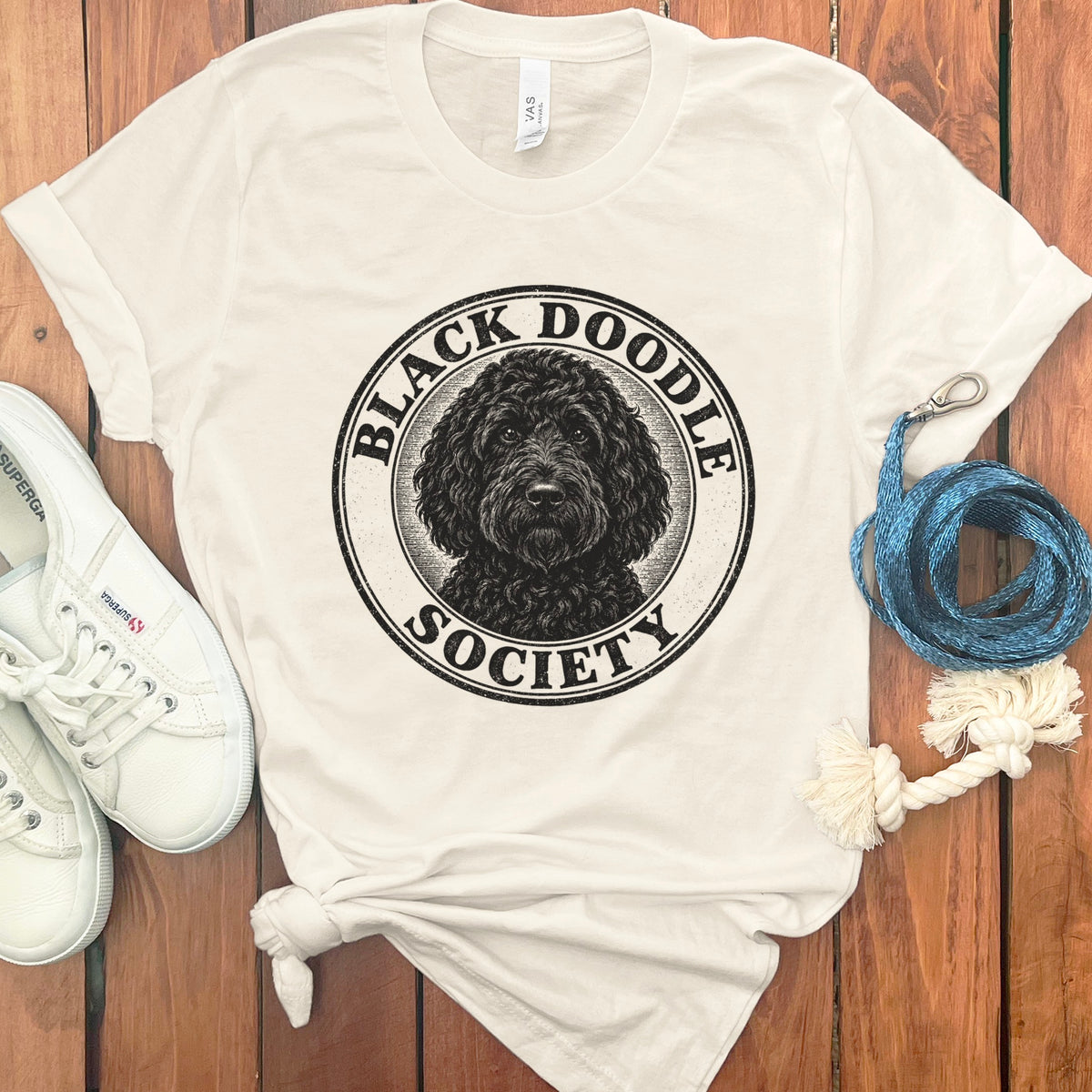 Cream t-shirt with a distressed circular logo of a black doodle dog and text "Black Doodle Society".
