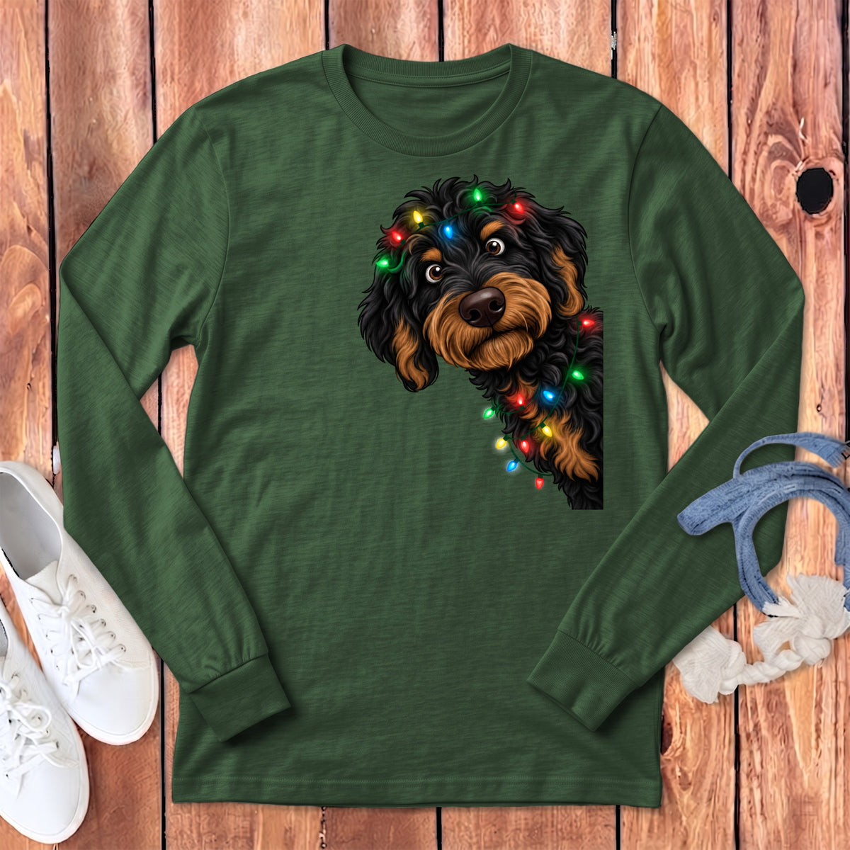 Green long-sleeve shirt with a doodle dog wearing Christmas lights.