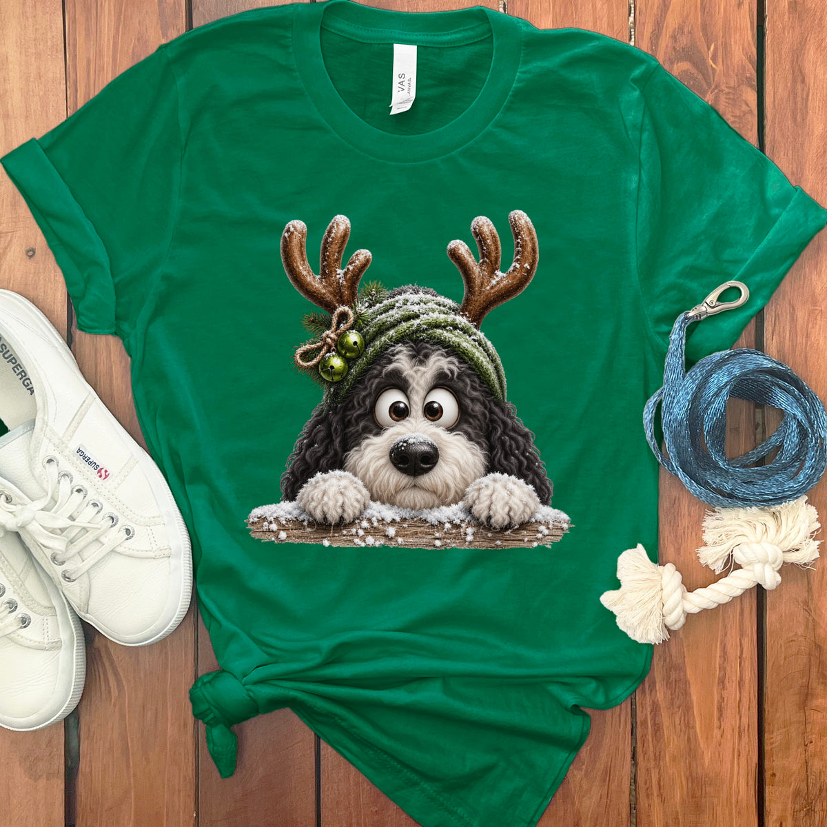 Green t-shirt with a cartoon dog wearing antlers and a winter hat.