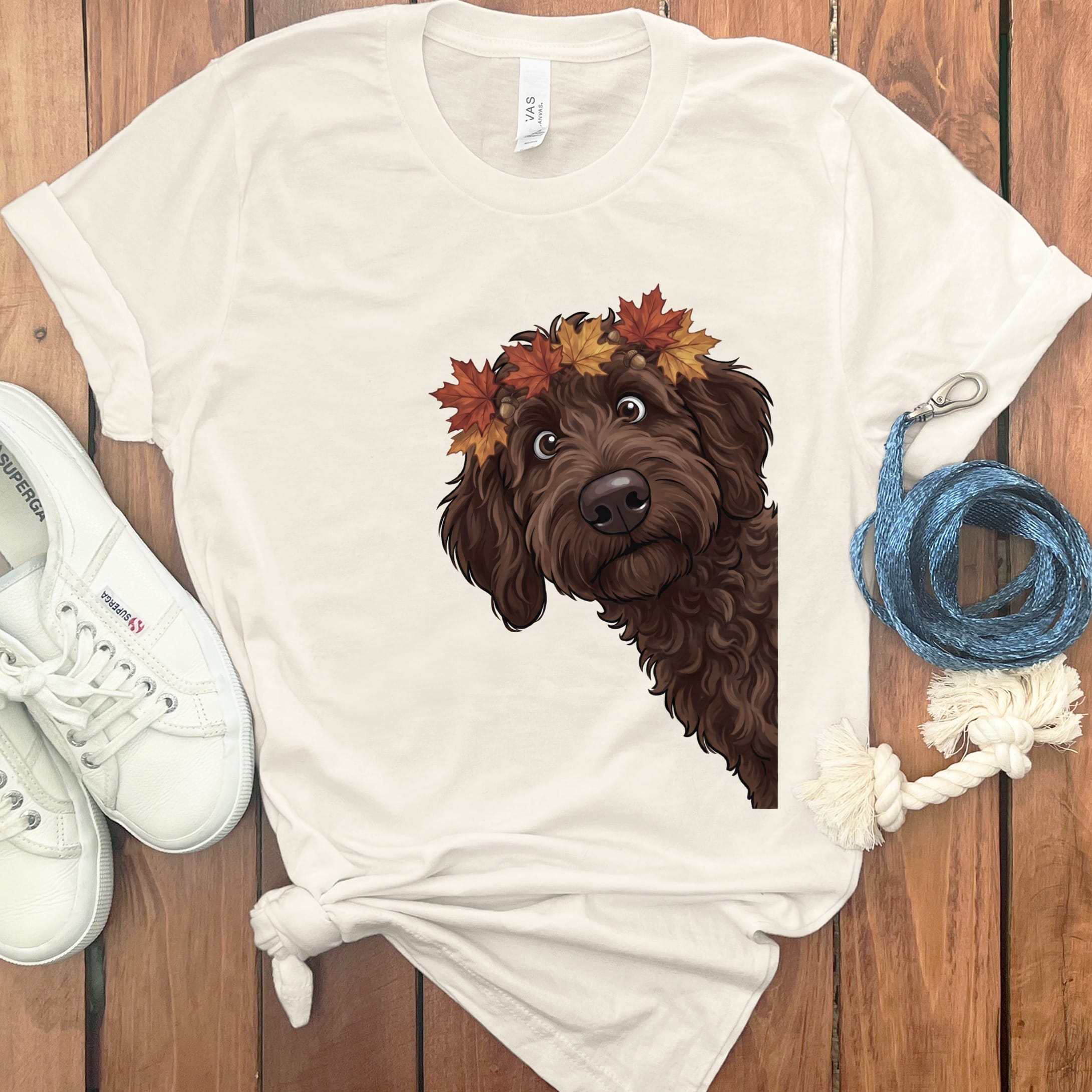Brown dog with autumn leaves crown on cream t-shirt.