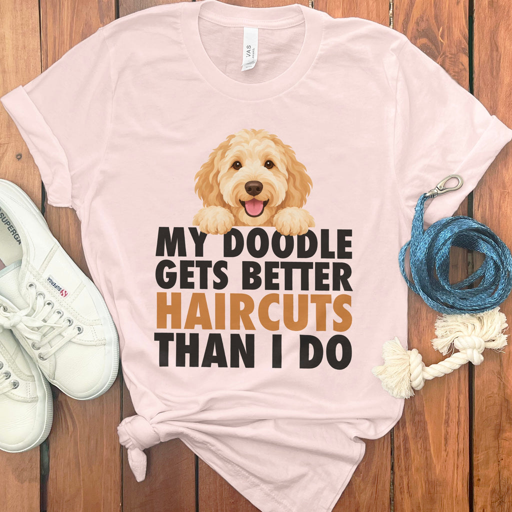 Light pink t-shirt with doodle dog graphic and text "My Doodle Gets Better Haircuts Than I Do".