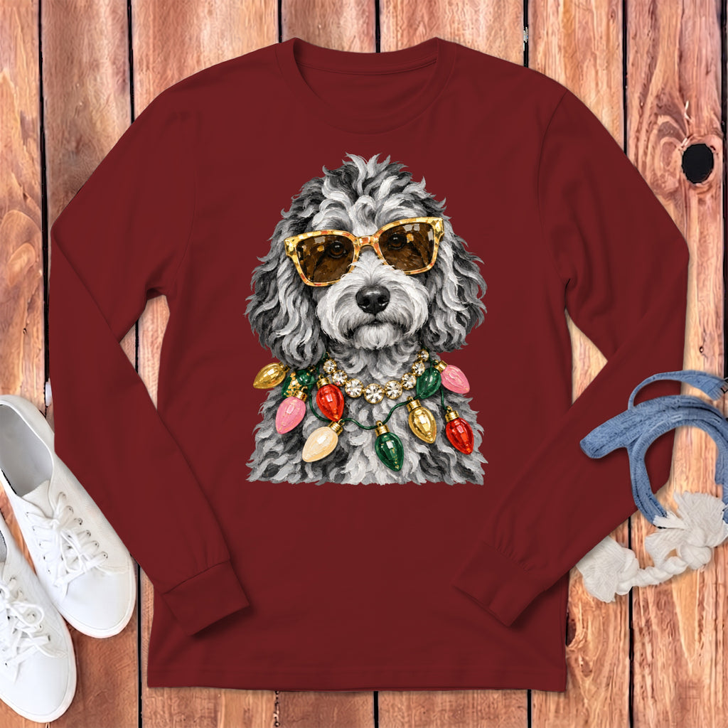 Dog with sunglasses and Christmas lights necklace on a maroon shirt.