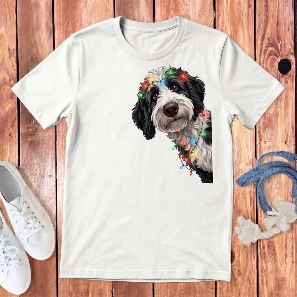 White t-shirt with black and white dog wearing colorful holiday lights.