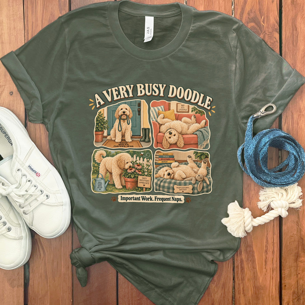 Green t-shirt with "A Very Busy Doodle" and four comic panels of a doodle dog.