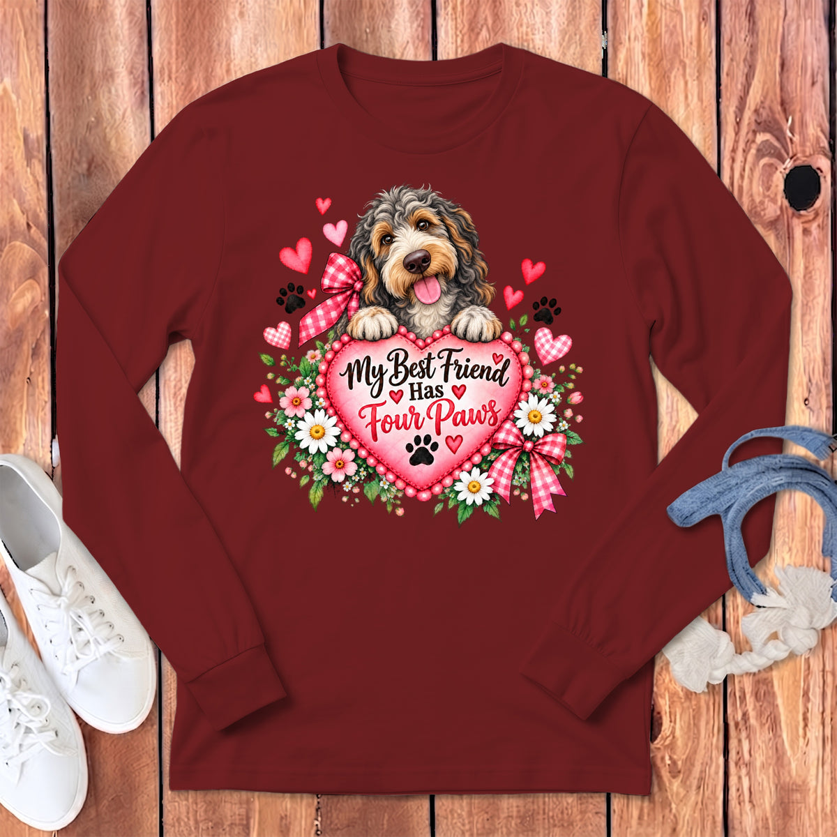 Maroon long-sleeve shirt featuring a dog graphic, flowers, hearts, and the text My Best Friend Has Four Paws.