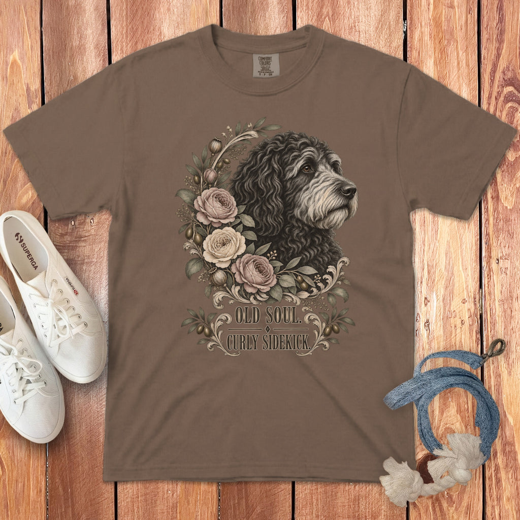 Brown t-shirt featuring a graphic of a curly dog, floral wreath, and the text Old Soul Curly Sidekick.