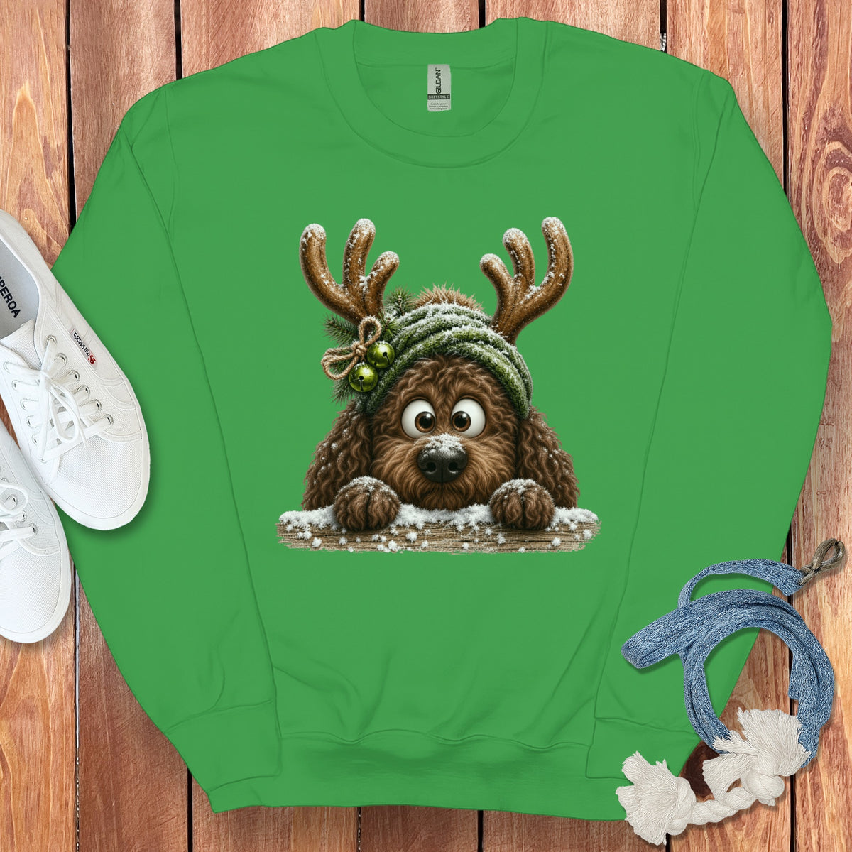 Green sweatshirt with cartoon dog wearing antlers and a beanie.