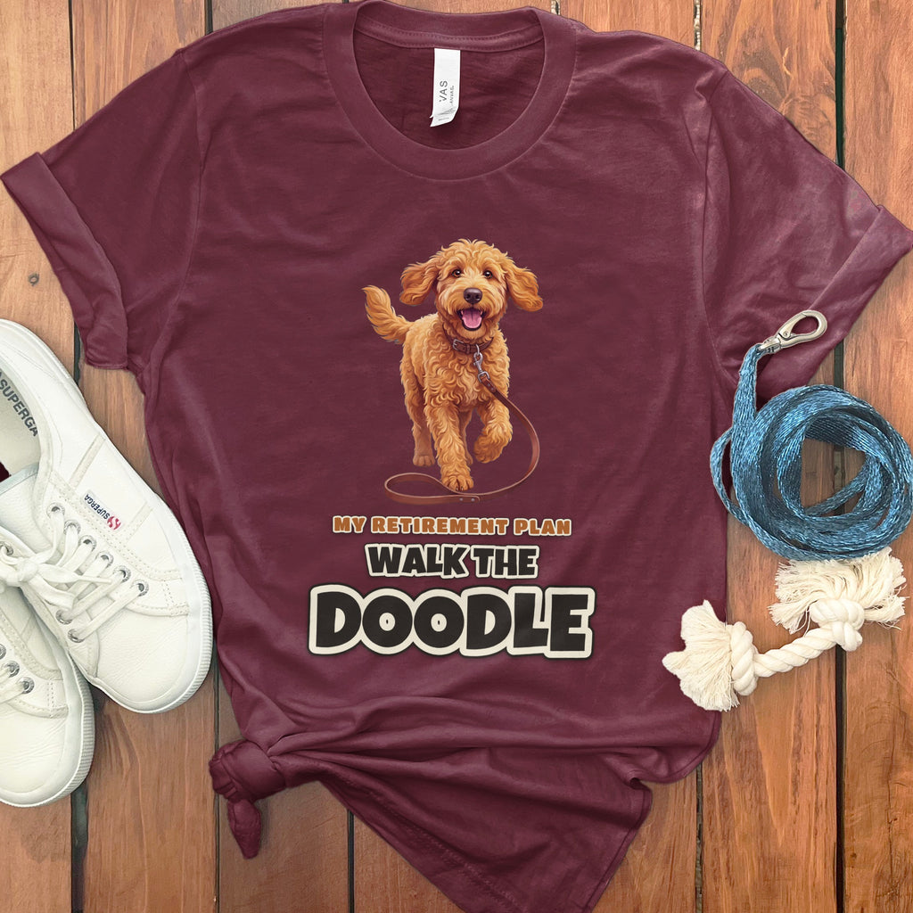 Maroon t-shirt with a walking doodle and "MY RETIREMENT PLAN WALK THE DOODLE" text.
