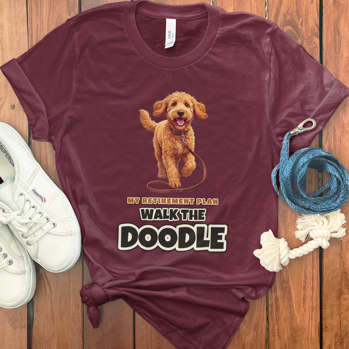 Maroon t-shirt with a walking doodle and "MY RETIREMENT PLAN WALK THE DOODLE" text.