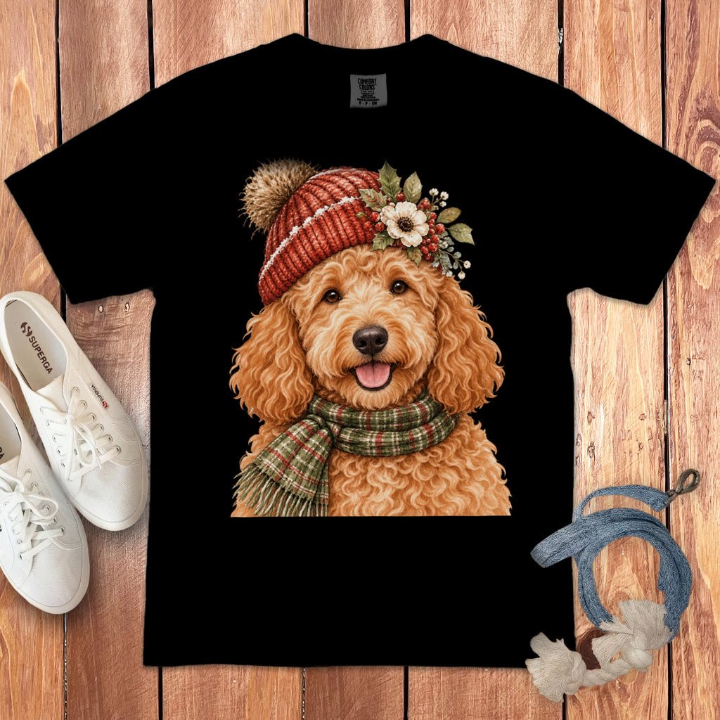 Black t-shirt featuring a cheerful goldendoodle wearing a red beanie and scarf.