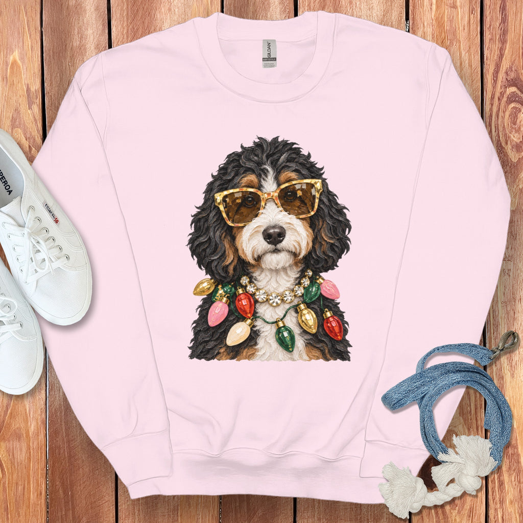 Pink crewneck sweatshirt with a dog wearing sunglasses and Christmas lights.