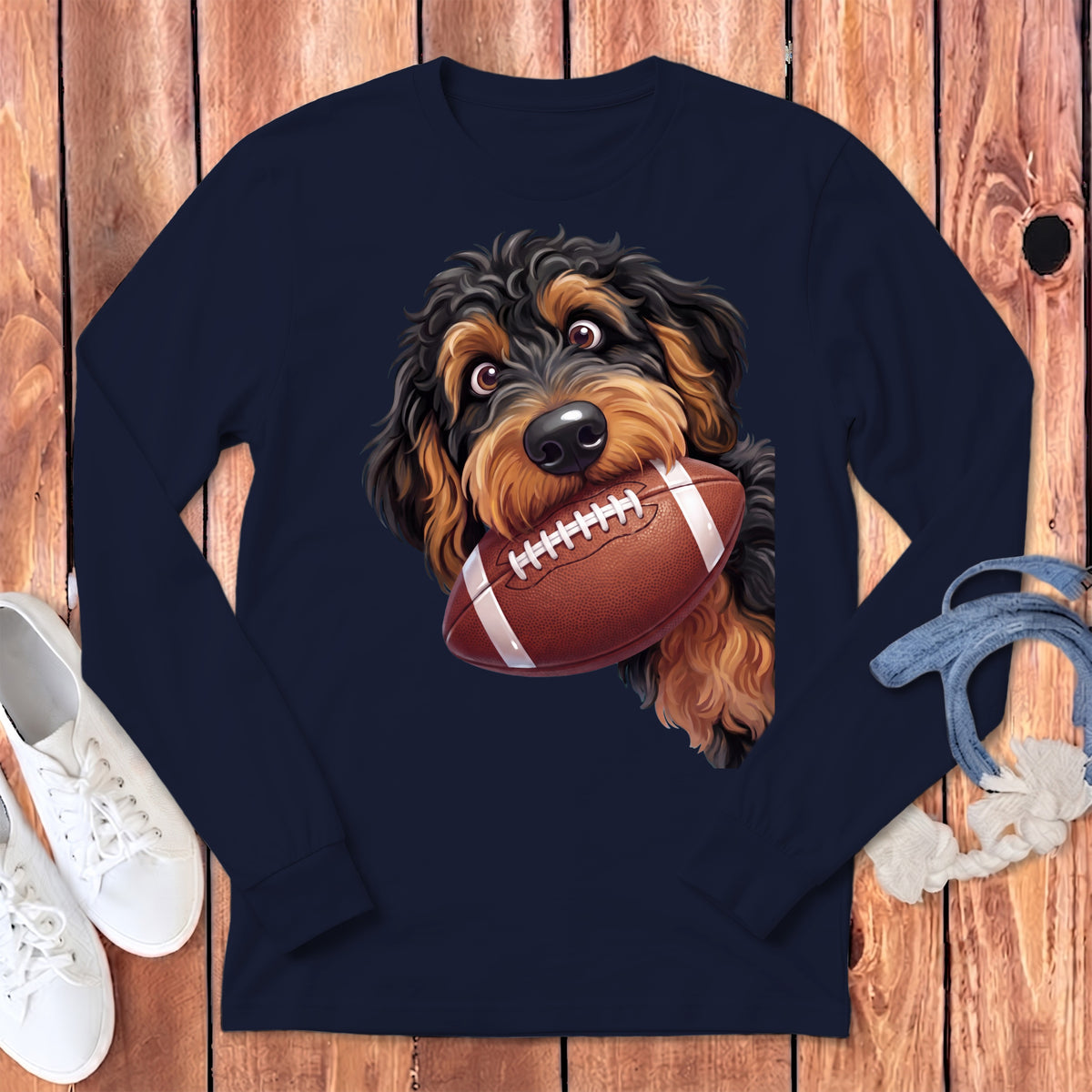 Dark navy long-sleeve shirt with a doodle-like dog holding a football in its mouth.