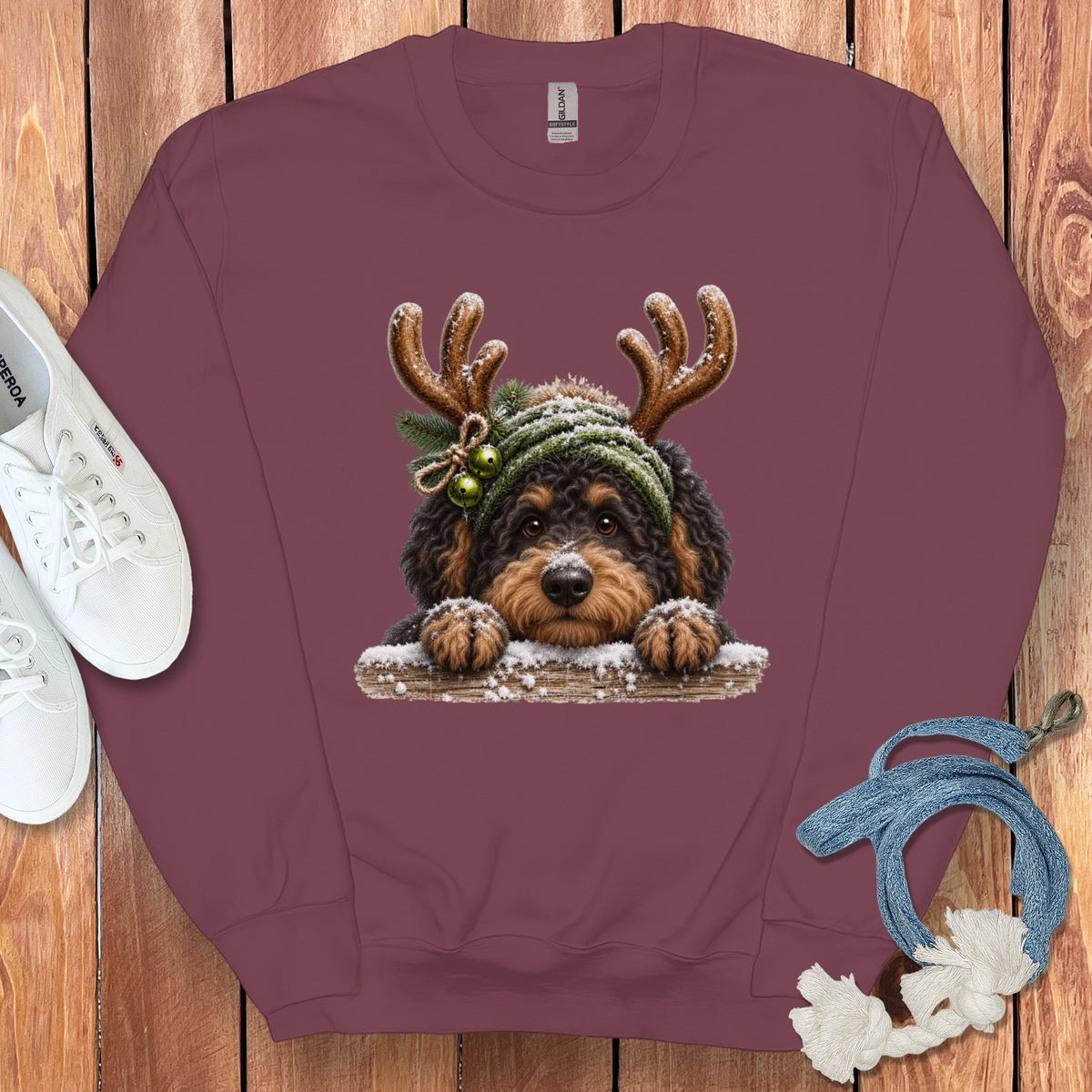 Burgundy sweatshirt with holiday dog graphic, white sneakers, and blue rope.