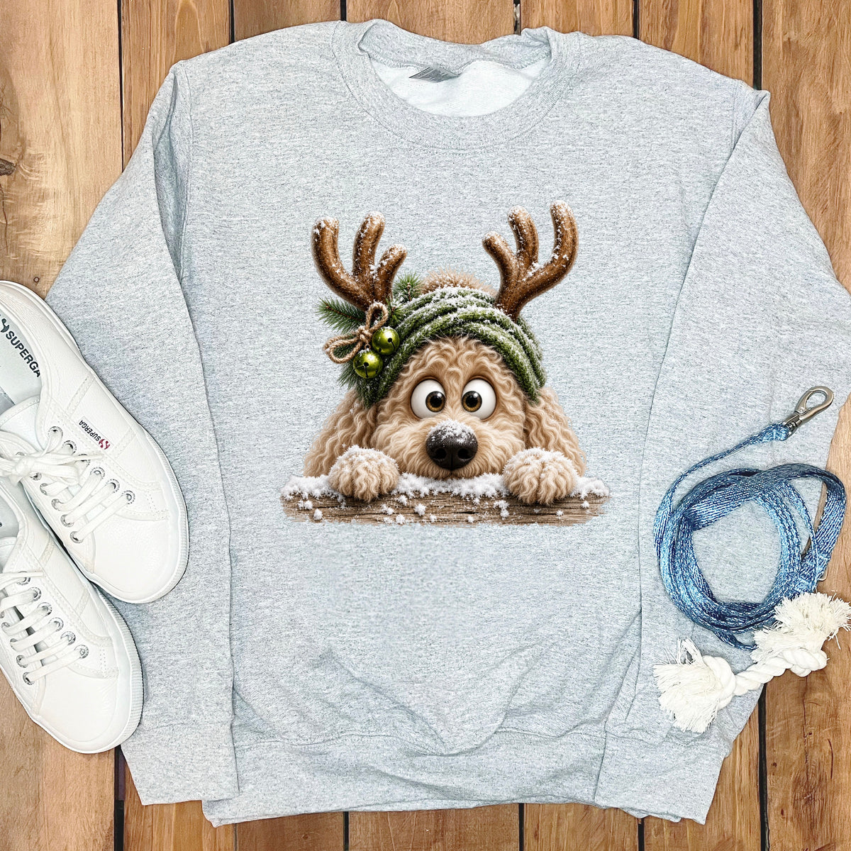 Gray sweatshirt with a cartoon dog wearing antlers and a green hat.