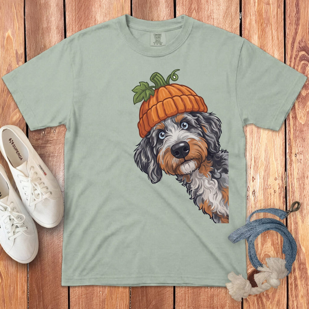 Light green t-shirt with illustration of dog wearing a pumpkin hat.