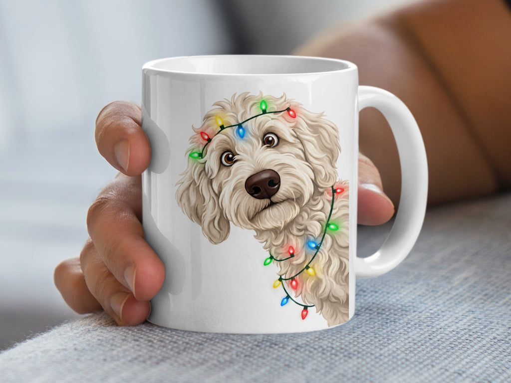 White mug with fluffy dog wearing colorful Christmas lights around head.
