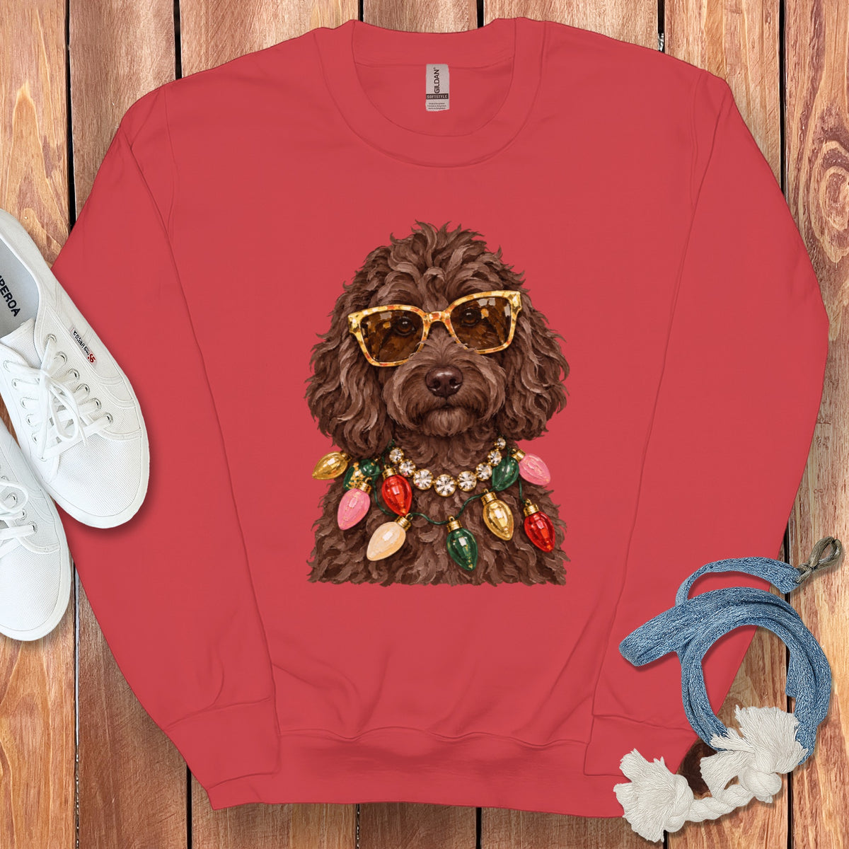 Red sweatshirt with a brown dog wearing sunglasses and Christmas lights.
