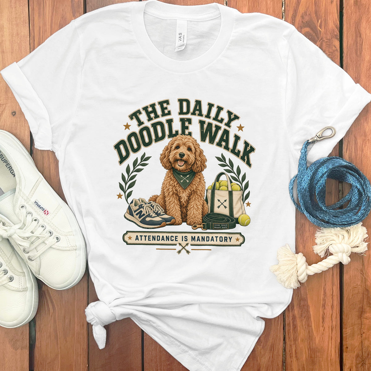 White t-shirt with a gold doodle dog graphic: "The Daily Doodle Walk".