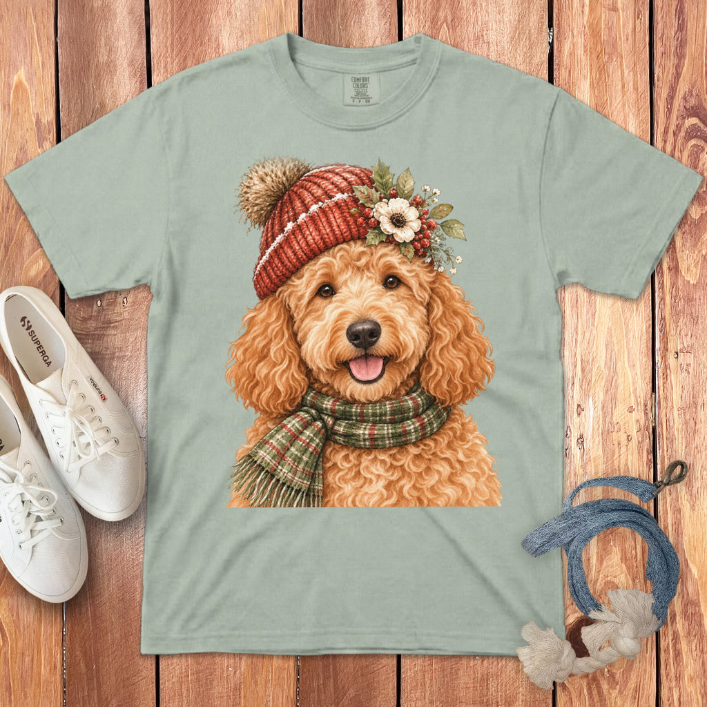 Light green t-shirt featuring a watercolor doodle dog wearing a red knit hat and scarf.