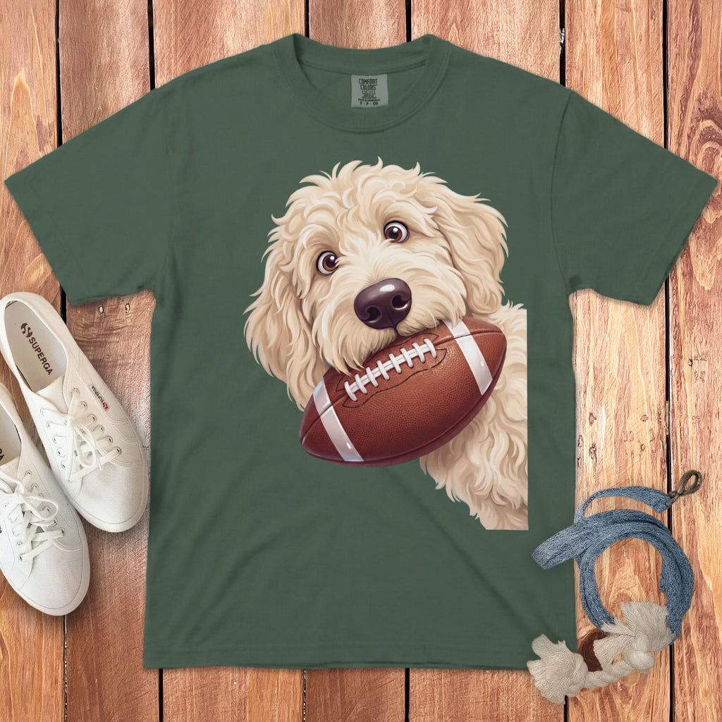 Green t-shirt with a cartoon doodle dog holding a football.