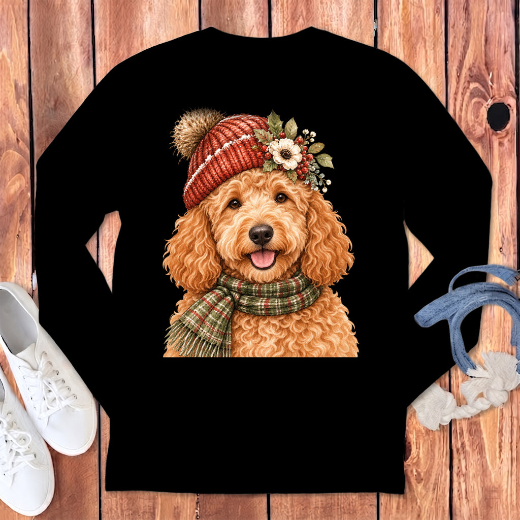 Goldendoodle wearing a festive winter hat and scarf on a black long-sleeve shirt.