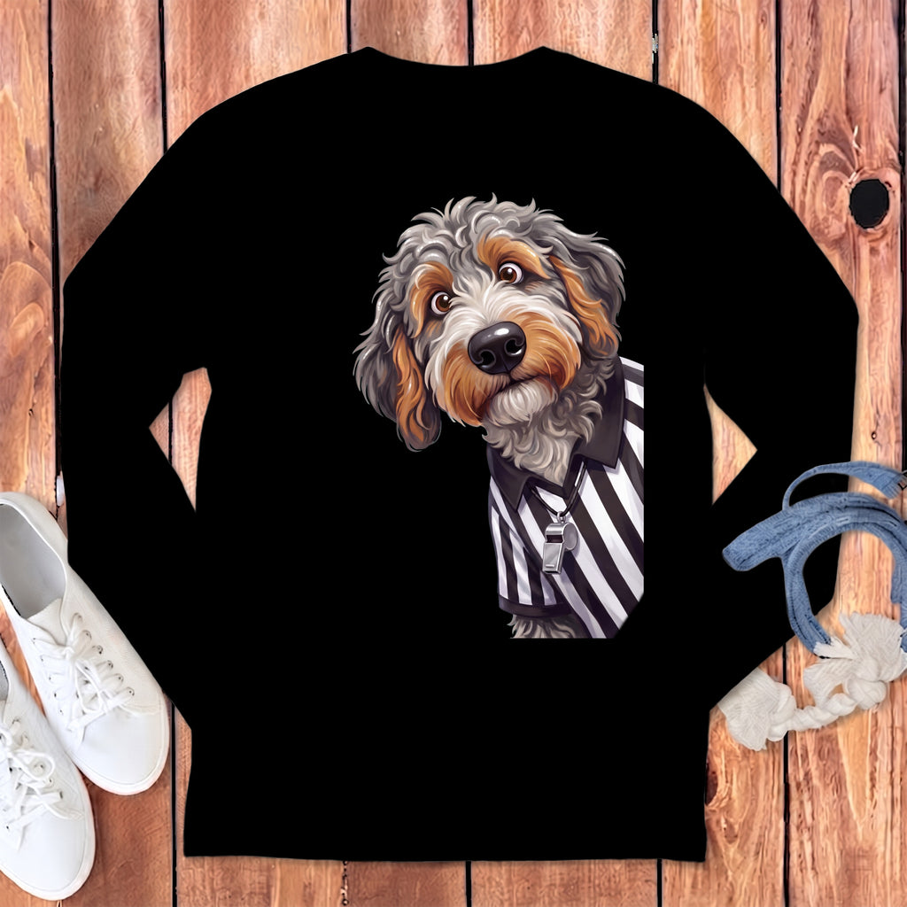 Fluffy dog wearing referee shirt with whistle on black long sleeve shirt.
