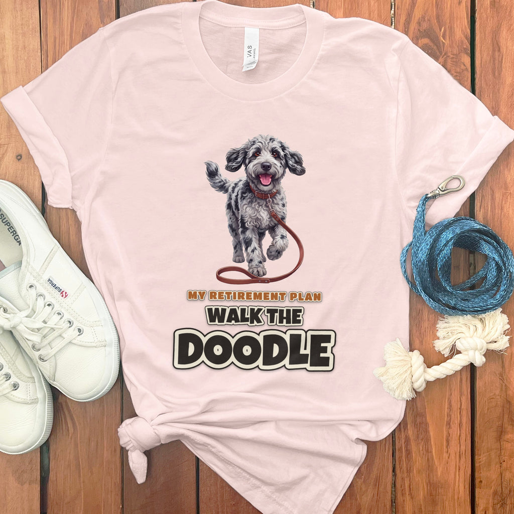 Pink t-shirt with a doodle dog illustration and text "MY RETIREMENT PLAN WALK THE DOODLE".