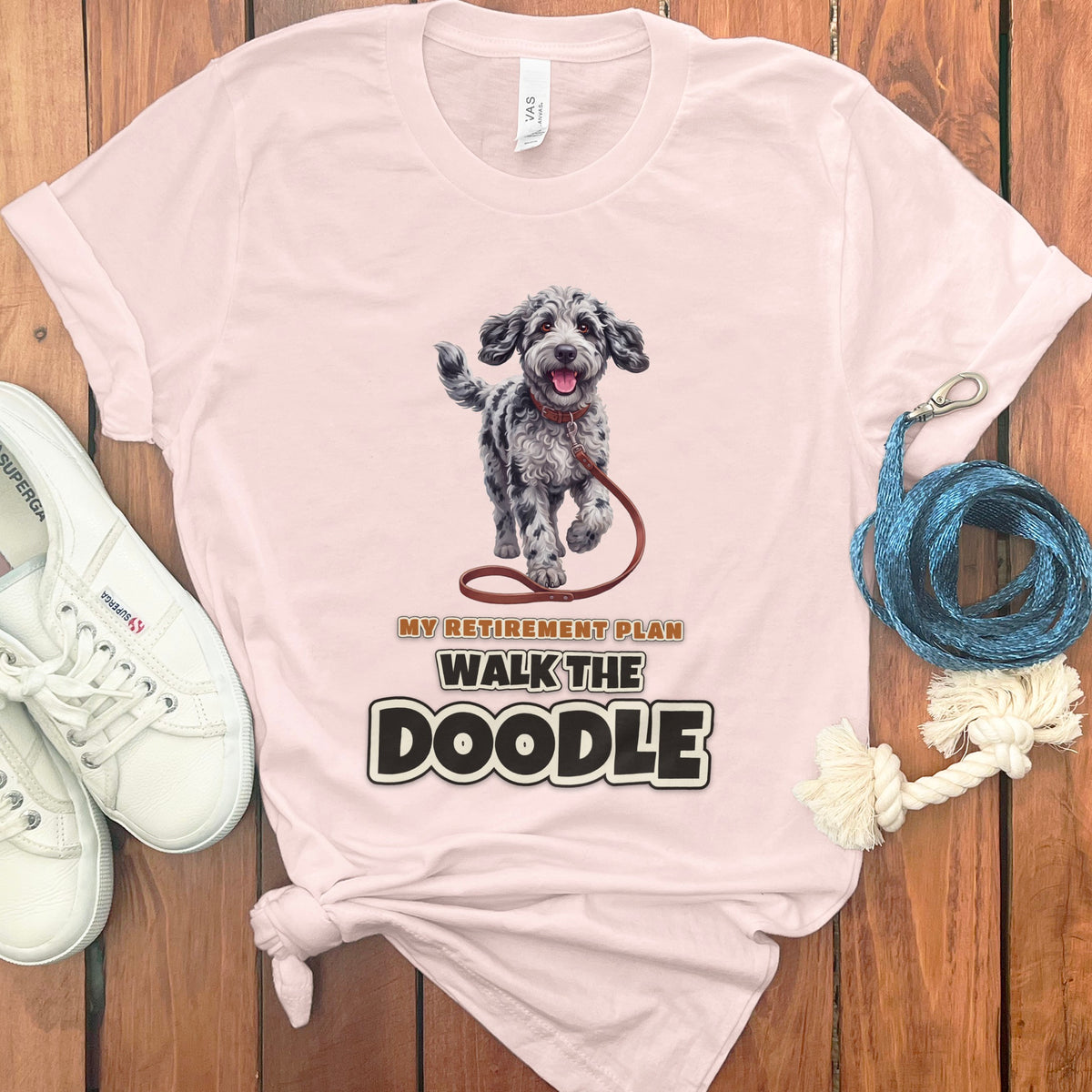 Pink t-shirt with a doodle dog illustration and text "MY RETIREMENT PLAN WALK THE DOODLE".