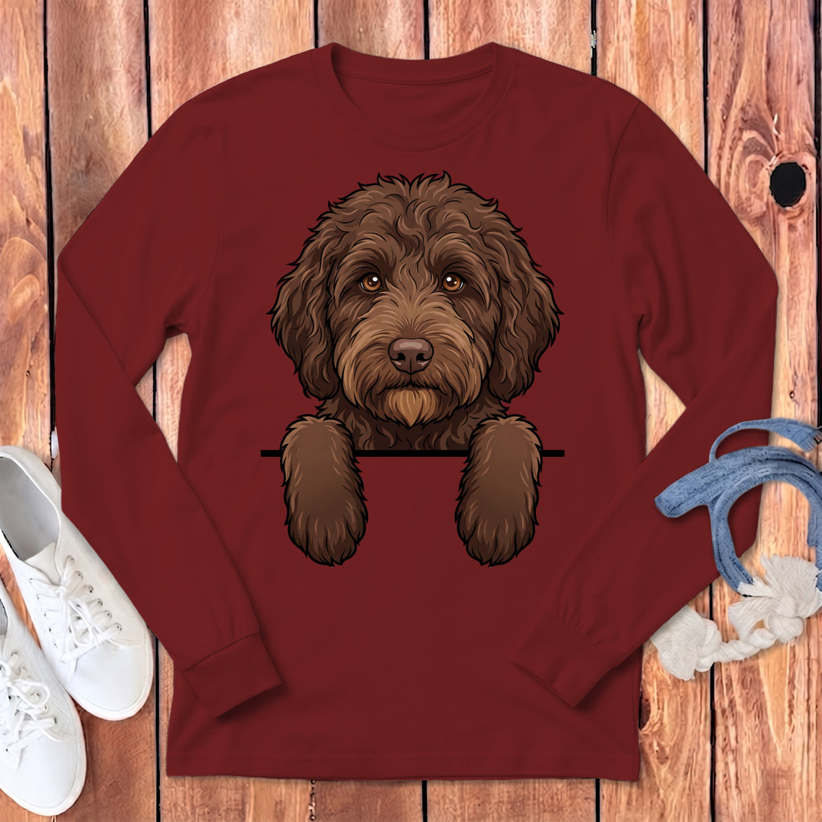 Maroon long-sleeve shirt with a cartoon brown dog peeking over a black line.