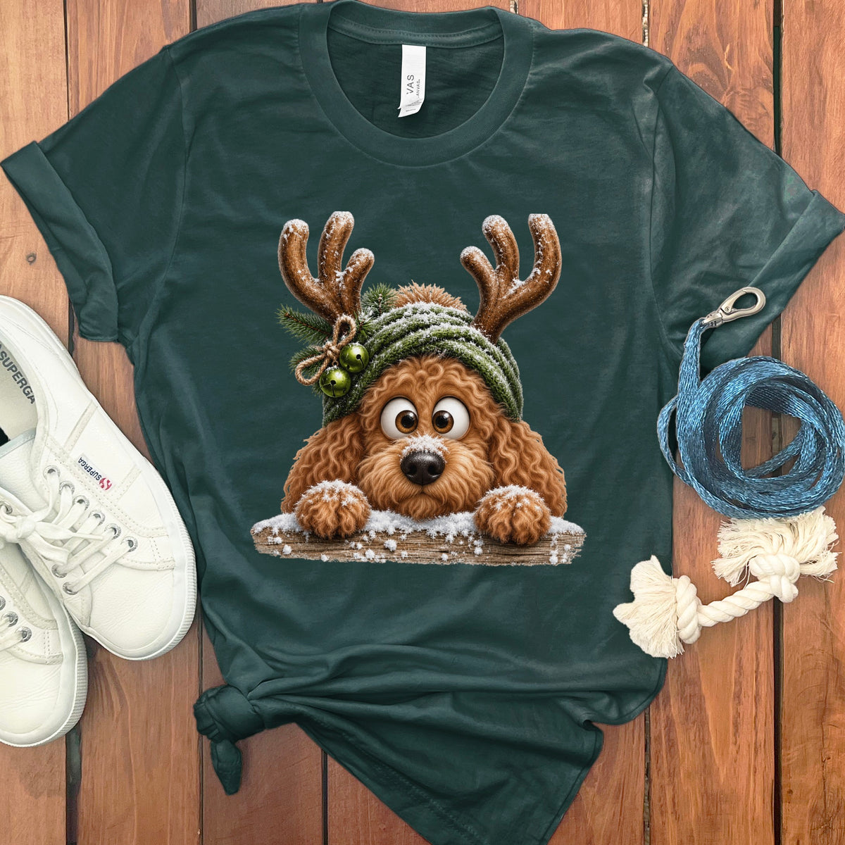 Dark green t-shirt featuring a cartoon dog with reindeer antlers and a knit hat.