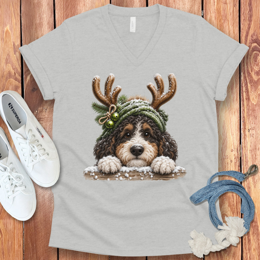 Bernedoodle puppy with antlers and snow on a v-neck t-shirt.