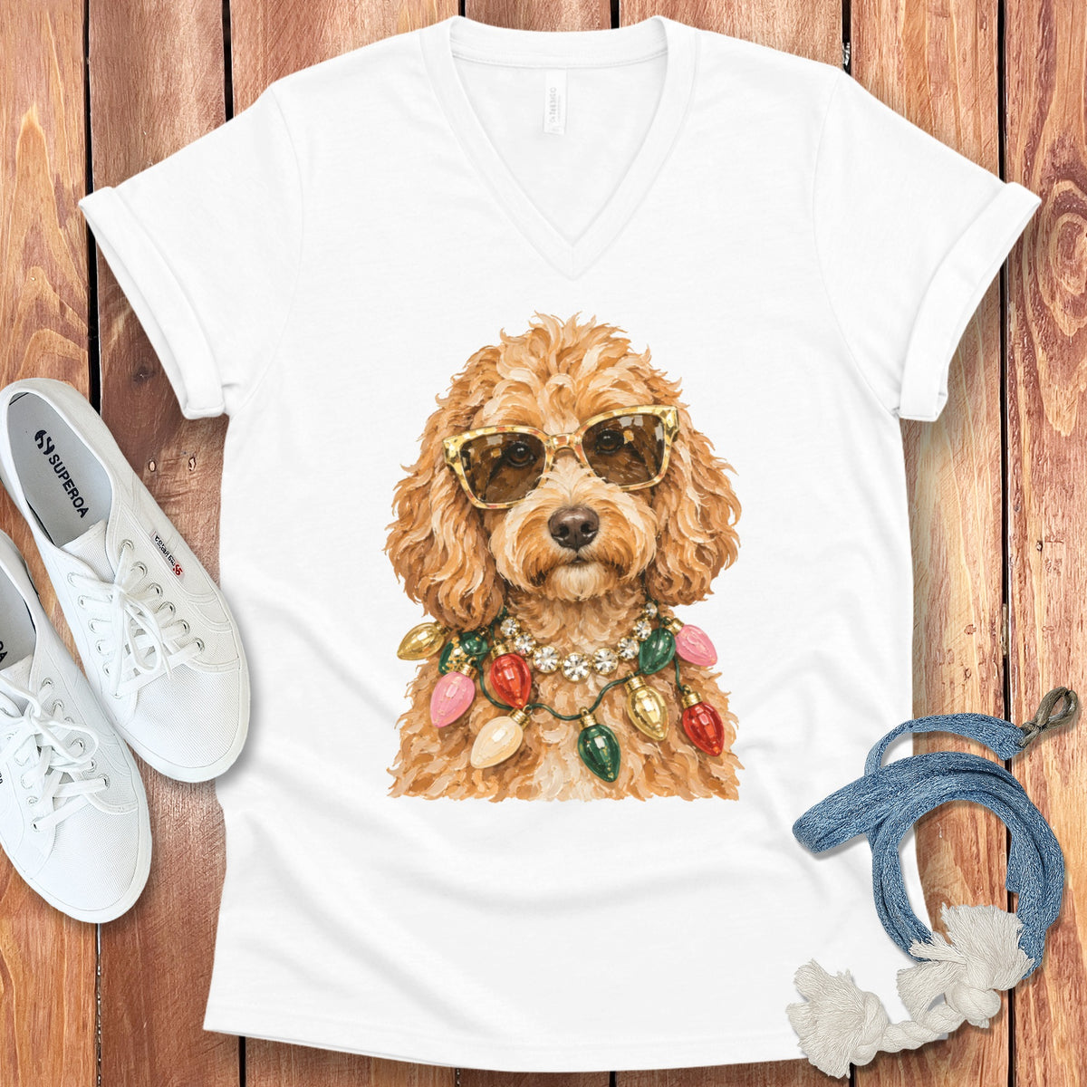 White t-shirt with a doodle wearing sunglasses and Christmas lights necklace.