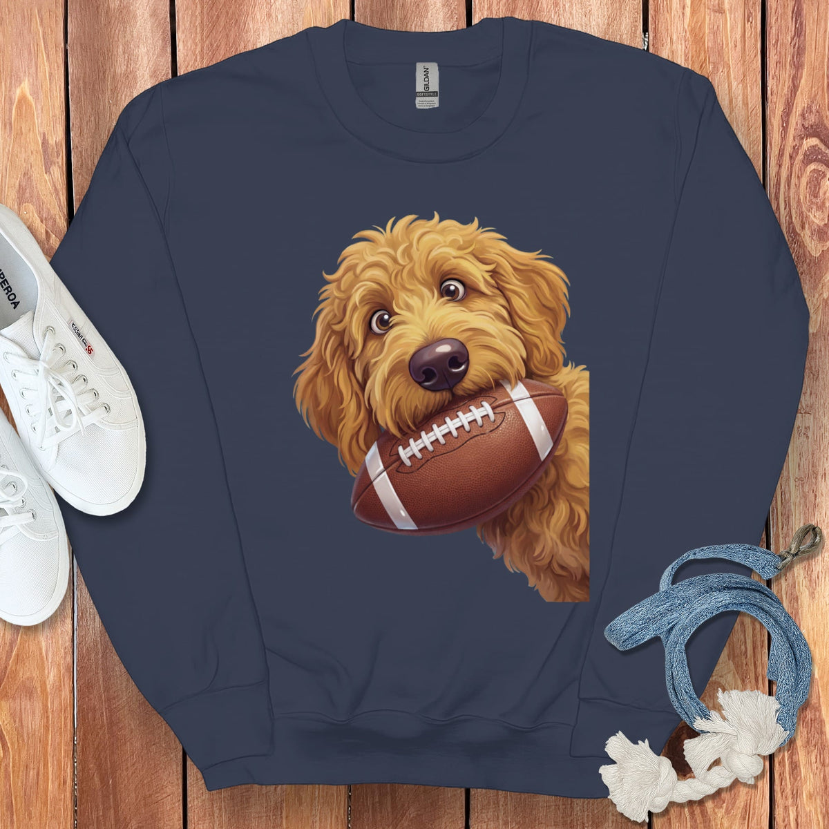 Navy sweatshirt with a golden doodle dog holding a football.