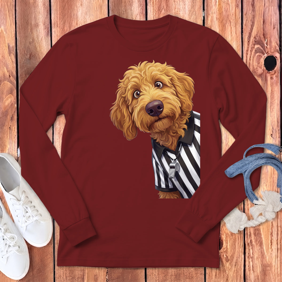 Maroon long-sleeve shirt with a goldendoodle dog wearing a referee shirt and whistle.