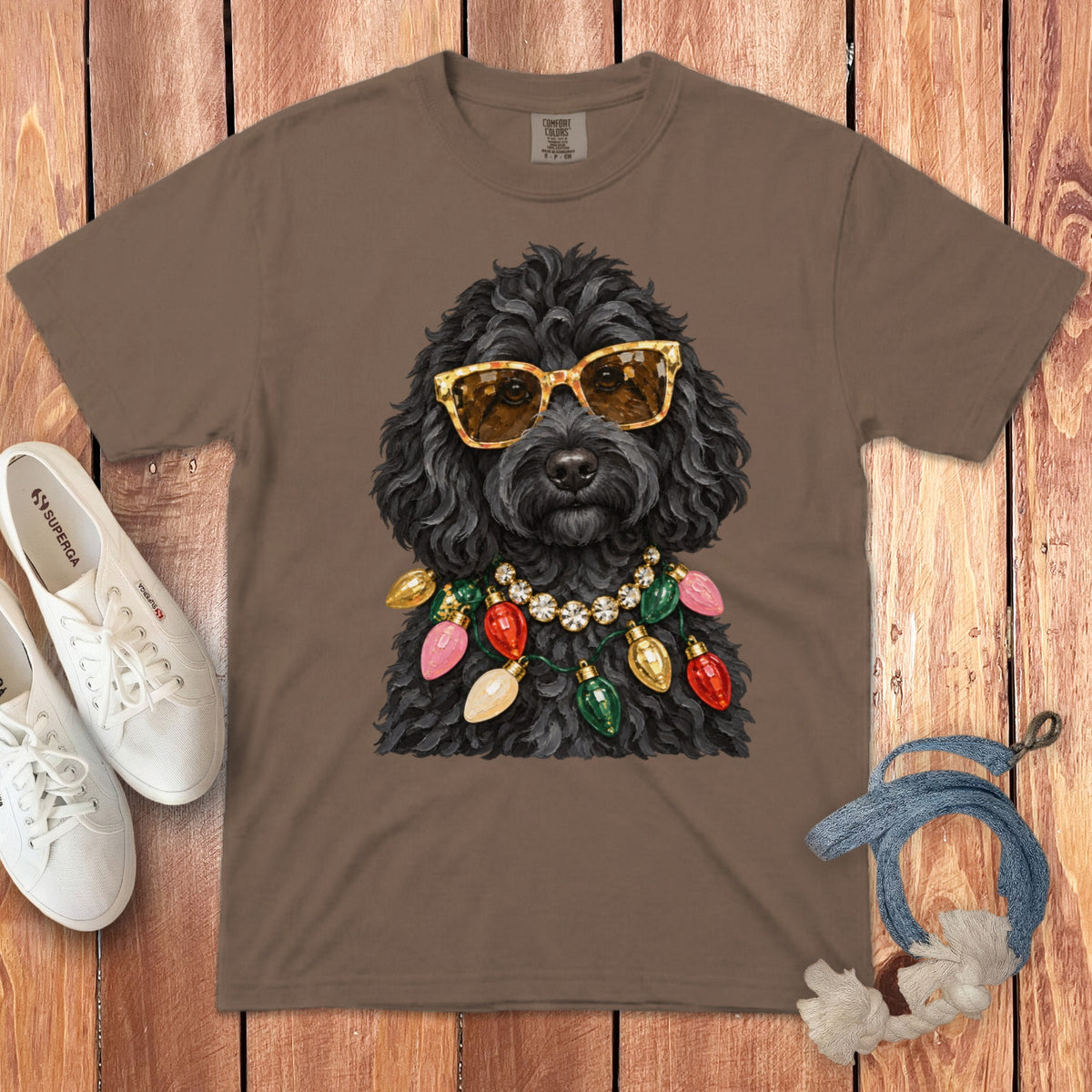 T-shirt with a black dog wearing sunglasses and a Christmas light necklace.