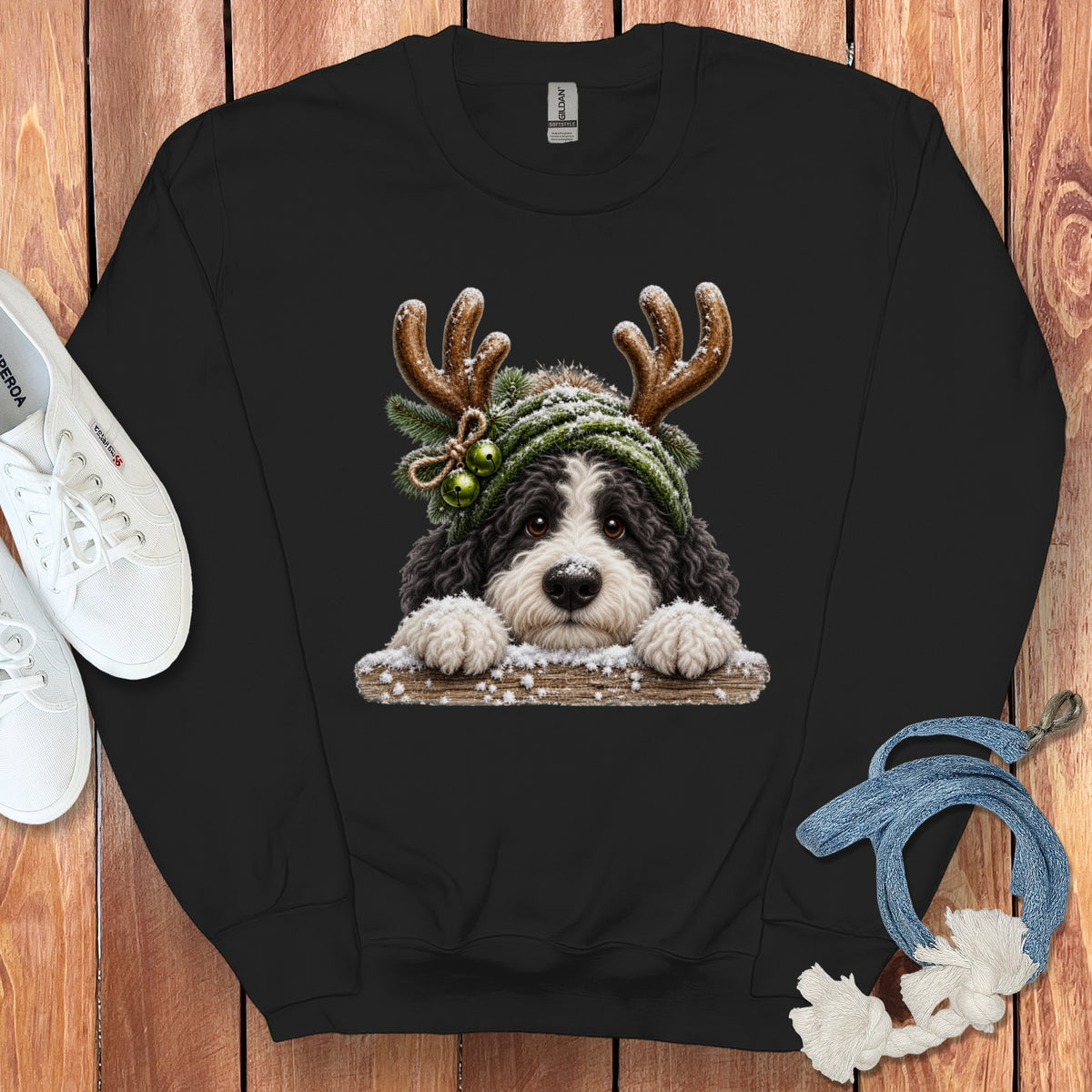 Black sweatshirt with a dog wearing reindeer antlers and a green hat.