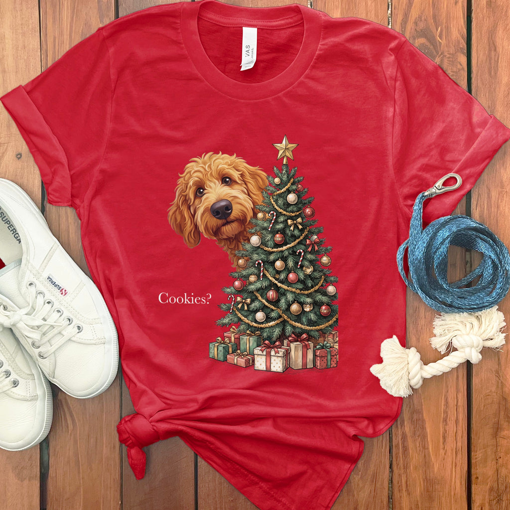 Red t-shirt with goldendoodle peeking around Christmas tree and gifts.