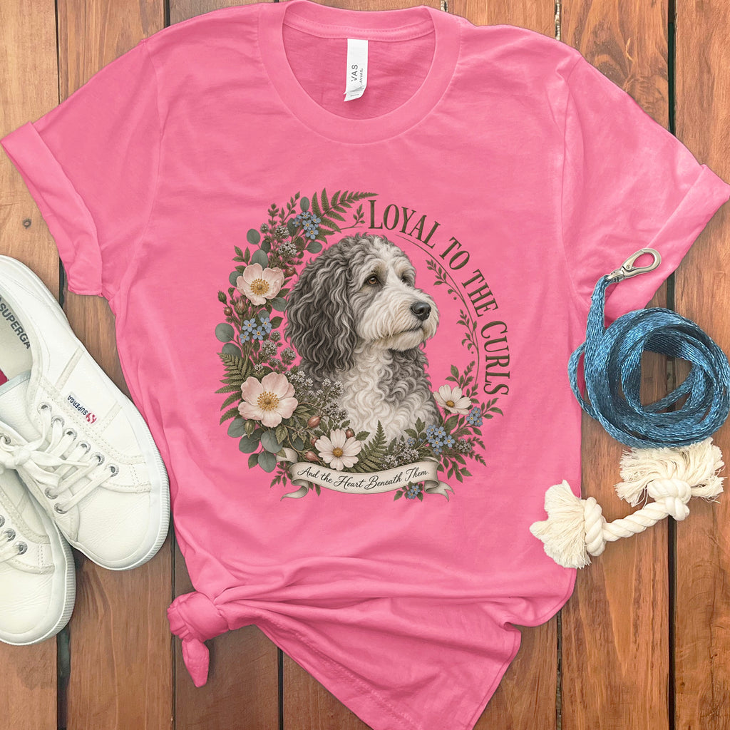 Pink t-shirt with dog portrait surrounded by flowers, text "Loyal to the Curls".
