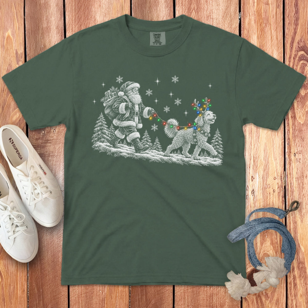 Dark green short-sleeve t-shirt featuring a white graphic of Santa walking a dog with reindeer antlers and Christmas lights.