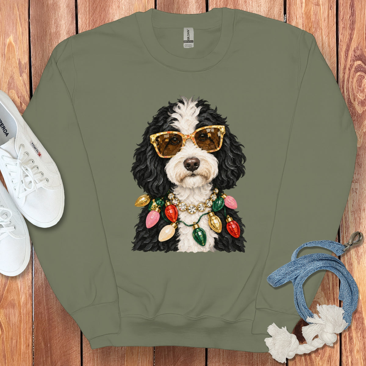 Green sweatshirt with a black and white dog wearing sunglasses and Christmas lights.